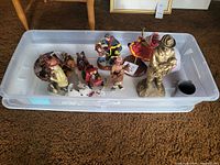 Top-down view of seven fireman figurines and collectibles, showing various poses and styles.
