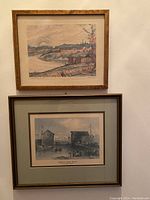 Two framed landscape prints displayed on a wall, showing relative size and framing.