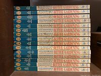 Photo of the spines of 15 hardcover gardening books by John Bradshaw, volumes 2 through 16, showing consistent design with the series title and volume number on the spine.