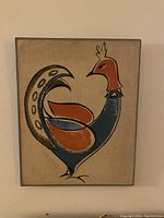 Front view of the canvas bird artwork showing stylized bird in blue, orange and beige on textured canvas.