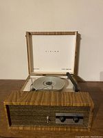 Front view of the Viking branded record player inside the wooden briefcase with lid open, showing the turntable platter and stylus arm.