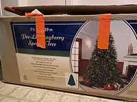 Photo of packaging for 7.5-foot pre-lit bayberry spruce Christmas tree, showing product features and size.