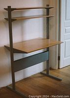 Image of assembled IKEA Fredrik computer desk showing wood surfaces and grey metal frame