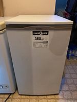 Front view of the Goldstar compact refrigerator showing the white door with EnerGuide label.