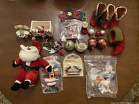 Overview photo showing entire assortment of Christmas ornaments and decorations on table.
