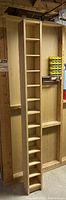 Straight front view of tall wooden CD rack showing all the small square shelves for CD storage.