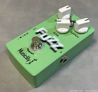 Top and angled view of green Musiclily fuzz pedal showing three white knobs labeled Level, Tone, and Sustain, toggle switch, footswitch marked True Bypass, input/output jack, and DC power input.