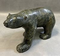 Front three-quarter view of the bear carving on neutral background