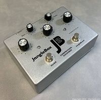 Top angled view showing control knobs, switches, and branding on pedal enclosure.