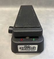Front view of black Jimi Hendrix Fuzz Wah pedal with label and red and green indicator lights.