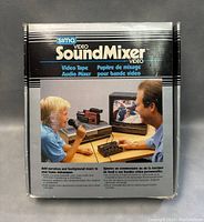 Front of original SIMA Video Sound Mixer box showing product branding and usage image with father and child using the device.