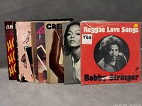 Ten vintage vinyl LP records shown with covers visible including Bobby Stringer Reggae Love Songs and others