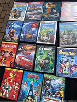 Top-down photo of 15 kids DVDs laid out showing titles and cover art clearly.