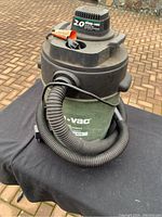 Shop-Vac showing 2.0 horsepower motor and green 5 gallon tank with hose wrapped around the body.