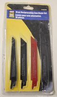 Front photo showing packaged 10 piece Power Fist reciprocating saw blade set with three visible blades of different teeth and colors (black and red)