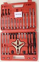 Open red plastic case showing all 35 pieces of the GRIP gear puller set neatly organized including bolts, puller arms, and main puller tool.