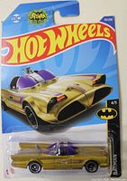 Front blister pack of the Hot Wheels Gold Batmobile showing the car and brand logo