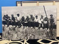 Front view of the large black and white canvas print featuring construction workers on a steel beam high above New York City.