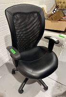 Front angled view showing chair back, padded armrests, contoured seat and base with caster wheels.