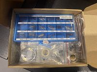 Overview of all watch parts in cardboard box