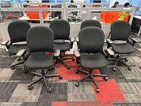 Front view of six black Steelcase Leap chairs arranged in two rows