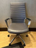 Front view of the Global Accord office chair showing grey vinyl upholstery and aluminum frame with caster wheels.