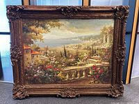 Full view of framed painting showing the Tuscan landscape and ornate gilt frame.