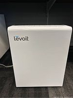 Front view of the white Levoit air purifier showing brand logo and general design.