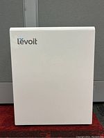 Front view of white Levoit air purifier with logo visible