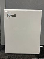 Front view of white Levoit air purifier showing logo and intake grille.