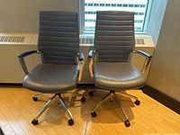 Front view of the pair of chairs showing overall condition and design