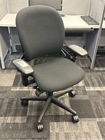 Front angle view of Steelcase Leap office chair showing seat, backrest, armrests, and casters.
