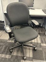 Front three-quarter view of chair showing seat, backrest, armrests and base