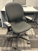 Front view of chair showing seat, base and caster wheels