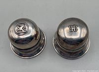 Top view of both closed round silver plated ring boxes showing hallmarks