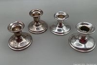 Four candle sticks shown together, two pairs, two with engraved bases, two plain with plate bases, one has liner.