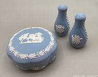 Blue Wedgwood Jasperware covered dish alongside matching salt and pepper shakers on a flat surface.