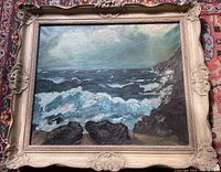 Full framed oil painting showing turbulent sea with rocky shore and cloudy sky.