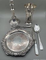 Full lot of silver plated items including candlestick, vase, tray, serving spoon, grape scissors, and knife.
