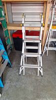 Full view of folded Mastercraft extension ladder in storage space.