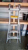 Full view of aluminum articulating ladder in A-frame configuration