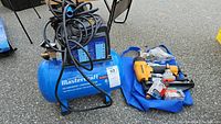 Both Mastercraft air compressor and Bostitch nail finisher with accessories displayed