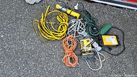 Photo showing all cords and trouble light laid out on ground