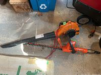 Worx WG508 blower and Black & Decker trimmer laid on floor showing overall condition and size comparison