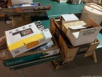 Photo showing several boxes stacked including wireless keyboards and the wireless backup camera kit box.
