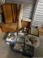 Overview showing two plastic bins, two compartment organizers, four wooden trays, and a box of publications