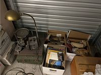 Overview of faceting machine with storage bins and boxes of magazines and craft materials