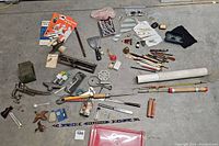 Overview of vintage tools, small bottles, pens, glasses, fishing pole and hair accessories