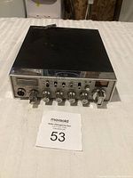 Top and front view of vintage Cobra CB radio showing control panel, knobs, and display.