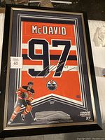 Full view of framed McDavid jersey print with number 97, name, Oilers logo, and signature